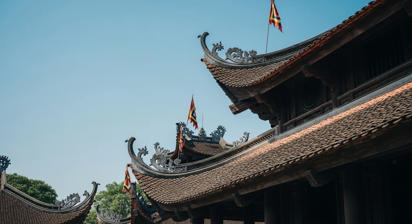 The ornate roofline of a Vietnamese royal temple at Lam Kinh with prayer flags